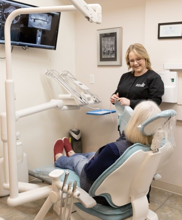 Sedation dentist in Cambridge talking to a patient in the dental chair